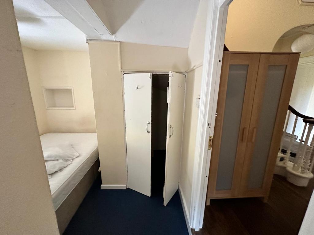 Cozy small bedroom with a single bed tucked int...