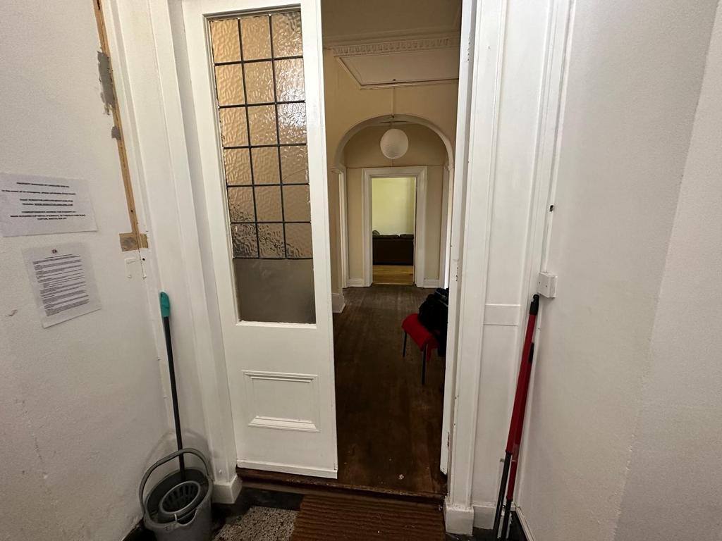 Welcoming entrance hallway with period door and...
