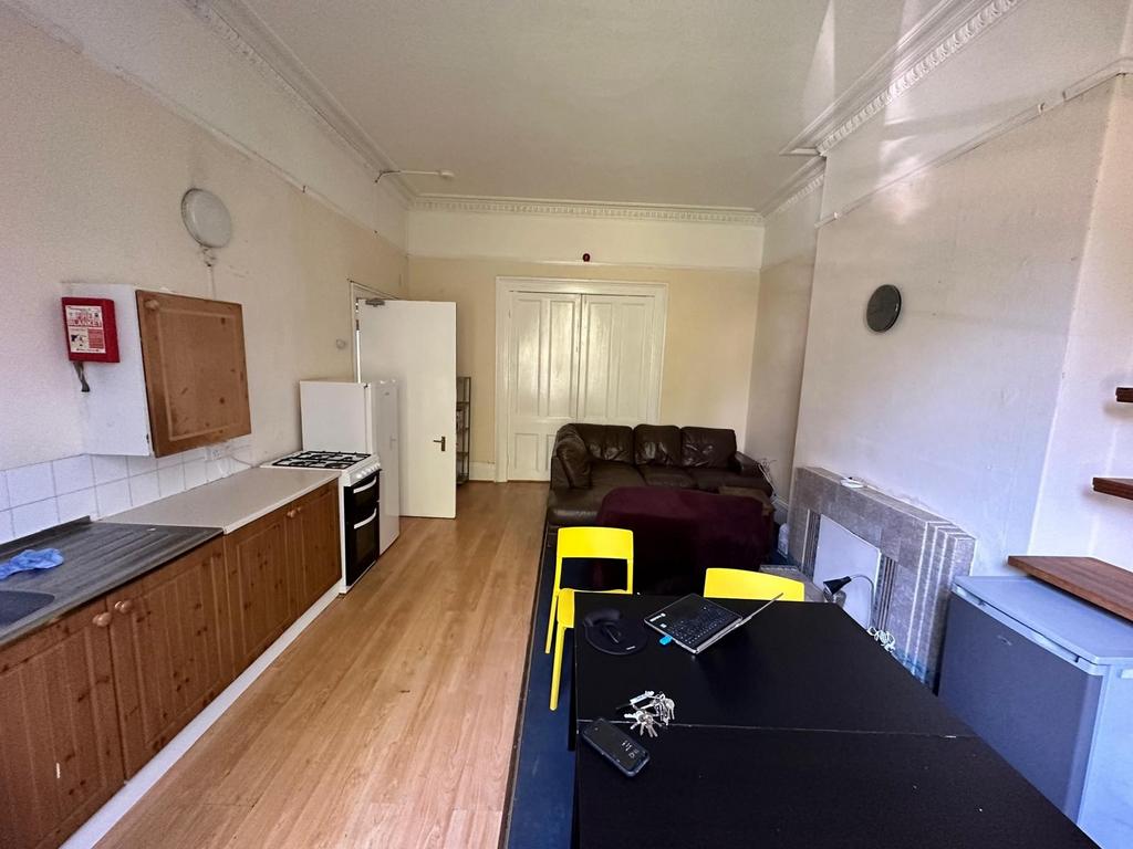 Open-plan kitchen and living area with a run of...