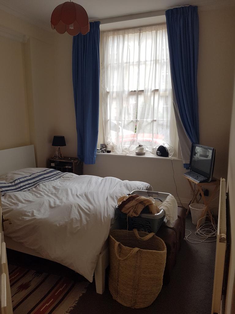 A cozy double bedroom featuring good natural li...
