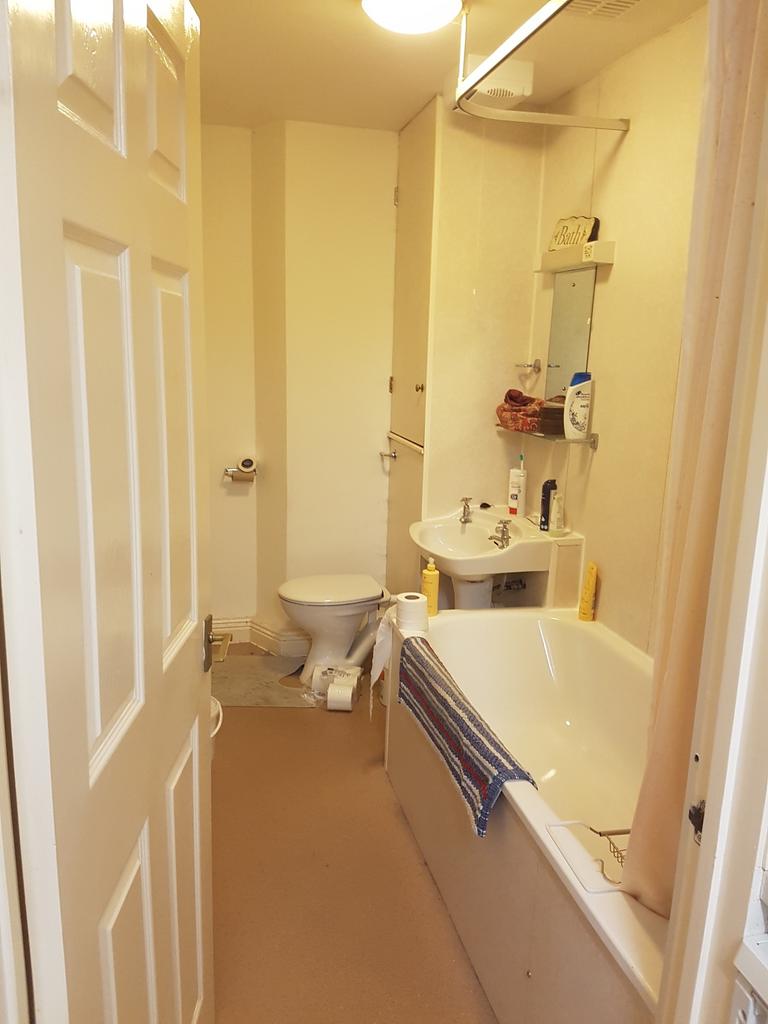 A tidy bathroom featuring a bath and essential ...
