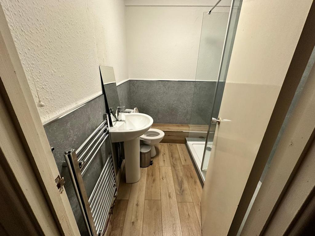 Modern compact bathroom with a pedestal sink, w...
