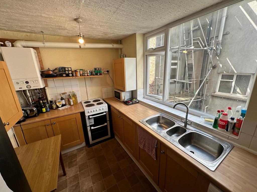 A spacious and well-lit kitchenette with modern...