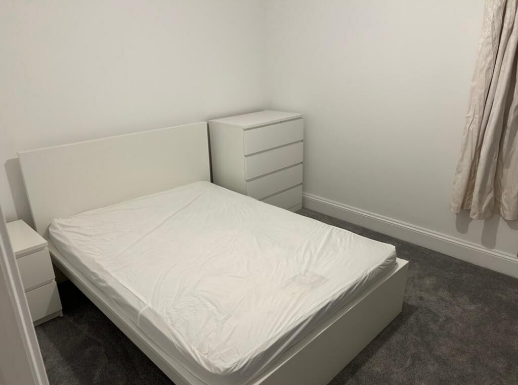 A bright and spacious double bedroom featuring ...