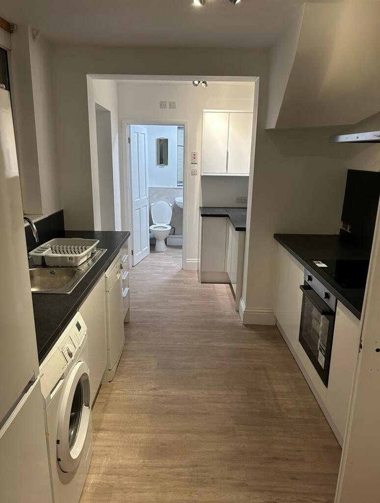 A spacious and modern kitchenette featuring sle...