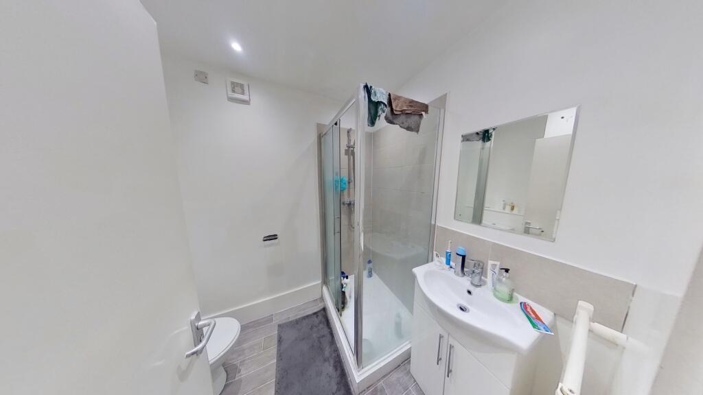 A modern and clean bathroom featuring a glass-e...