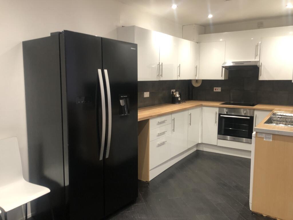 Modern kitchen featuring sleek black and white ...