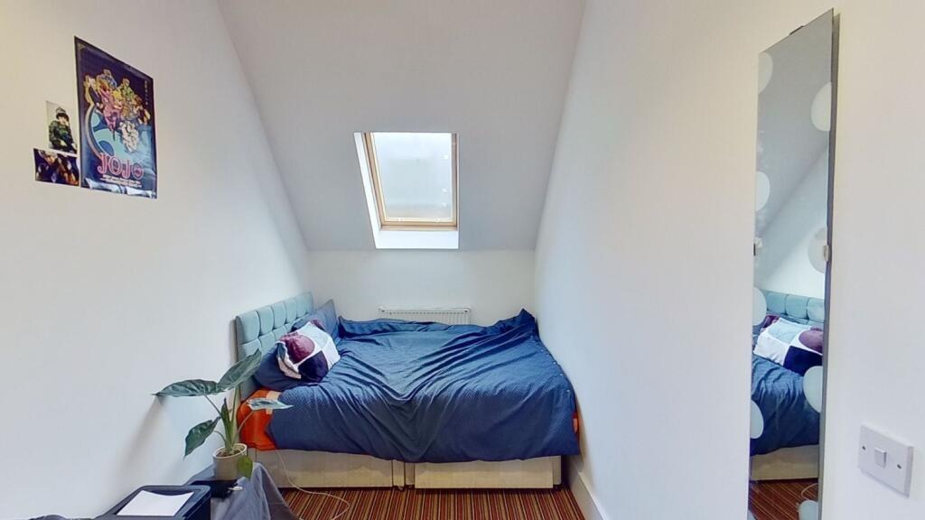 Bright and cozy double bedroom featuring a comf...