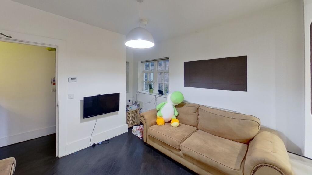 A cozy and neat living room featuring a comfort...