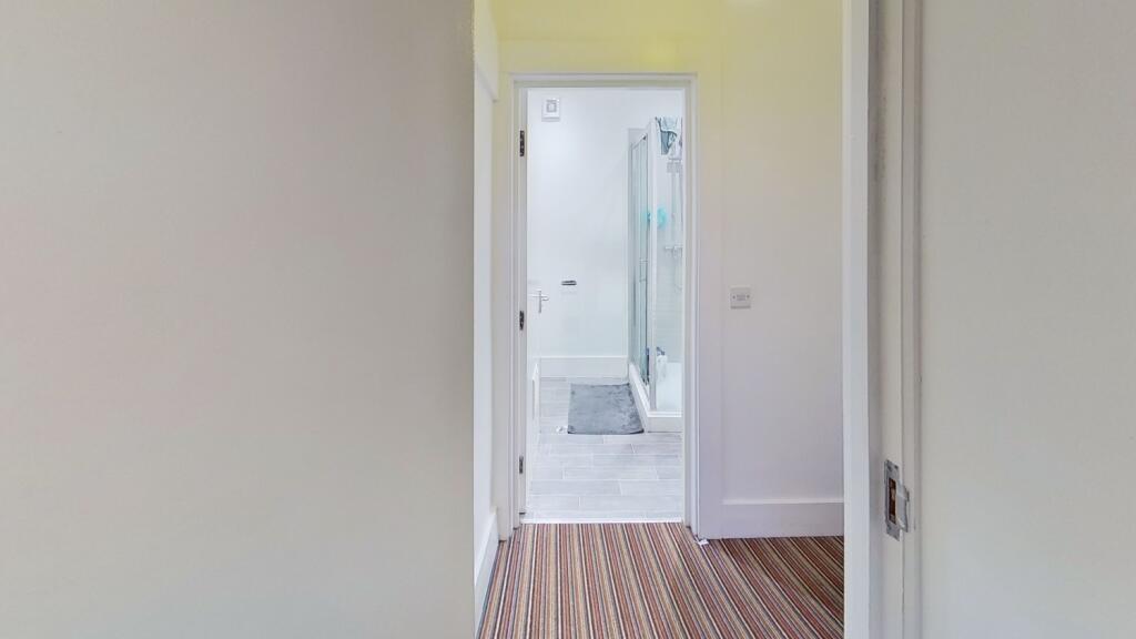 A clean and bright hallway featuring light-colo...