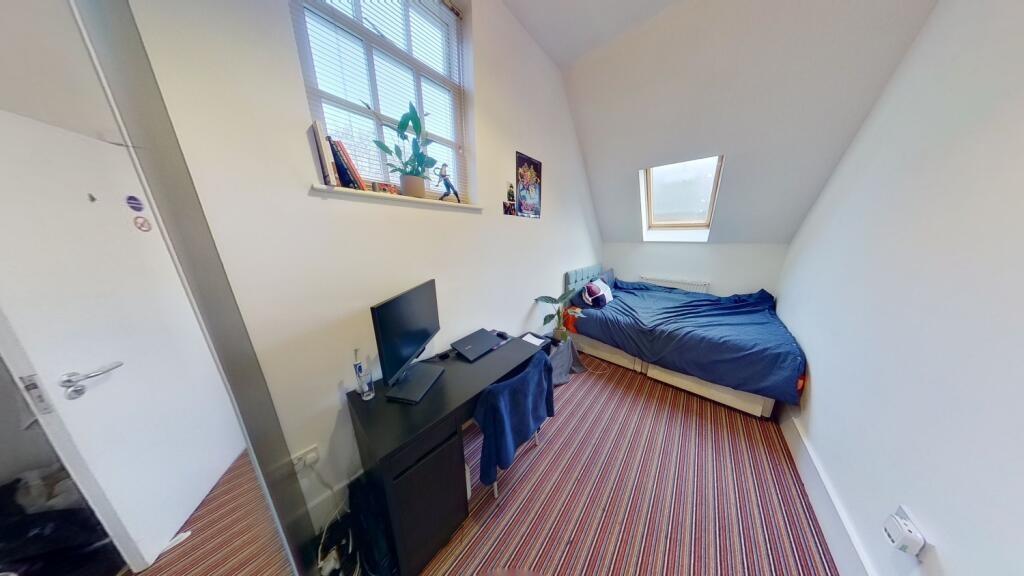 A clean and well-lit single toilet room with a ...