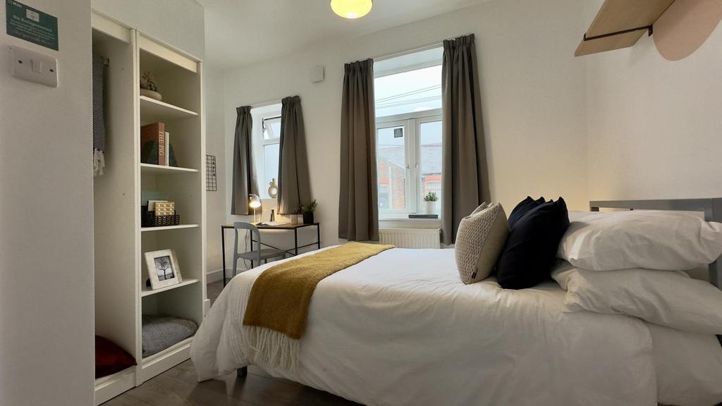 A bright and inviting double bedroom featuring ...