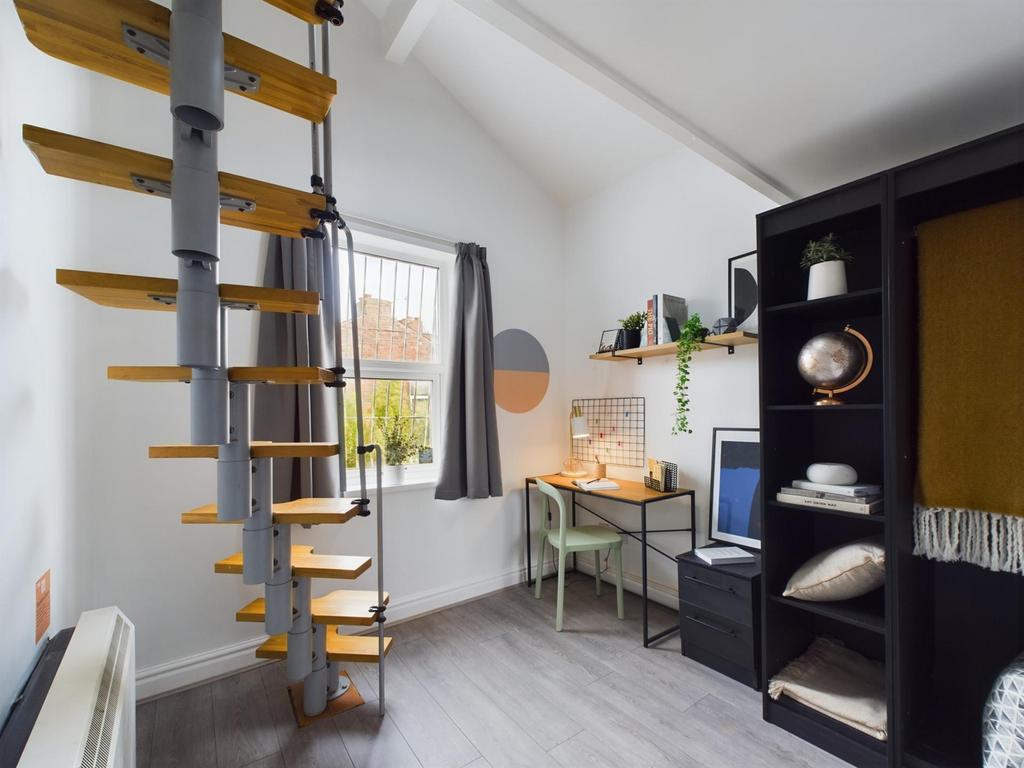 A bright and inviting communal workspace featur...