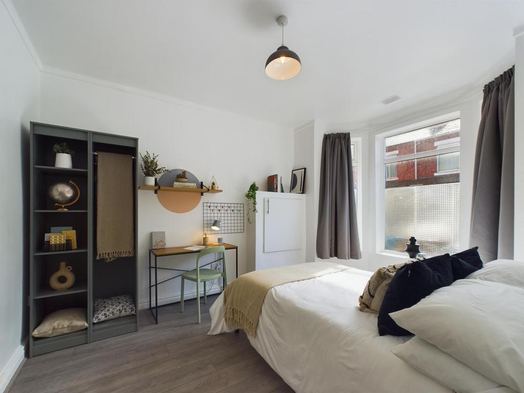 A bright and inviting double bedroom featuring ...