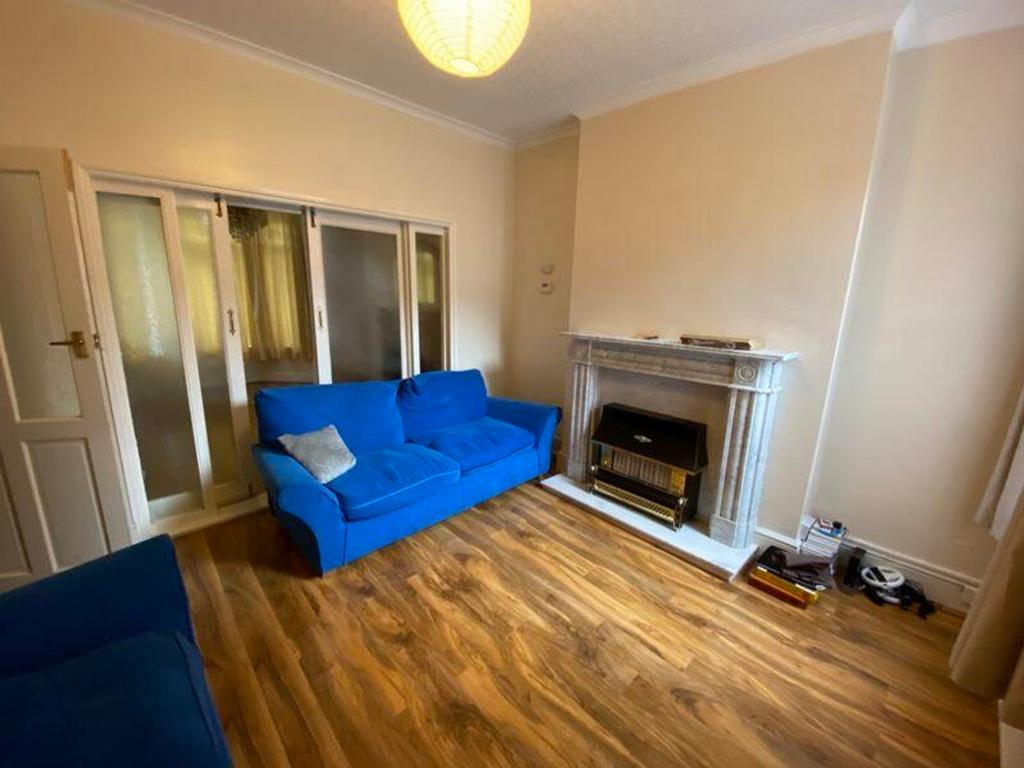 A cozy living room featuring a comfortable blue...