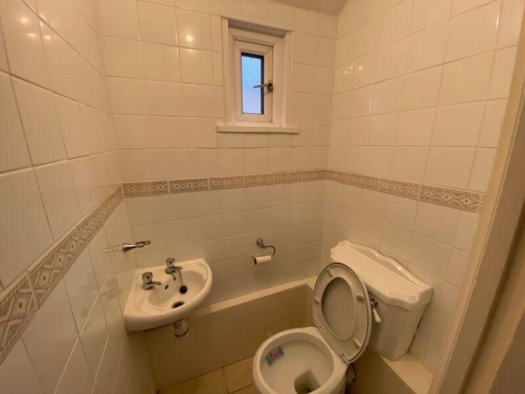 A tidy bathroom featuring modern tiles and esse...