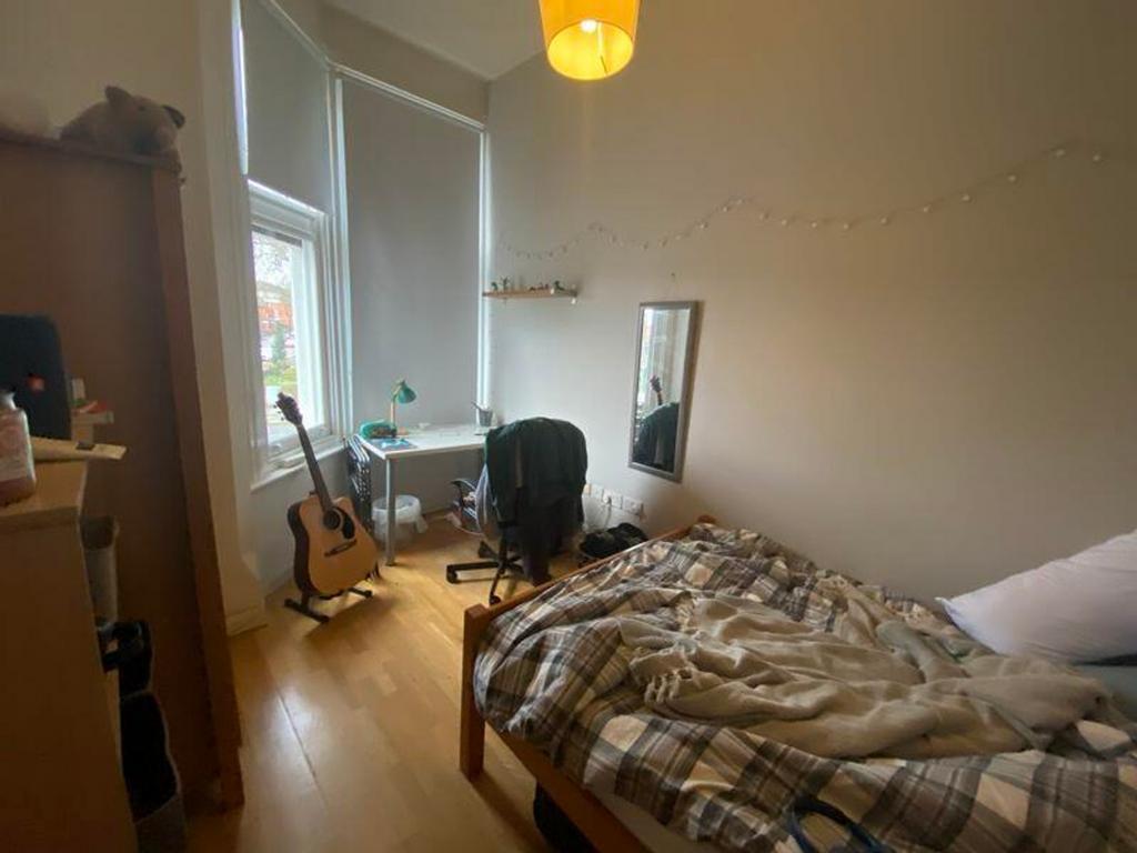 A cozy double bedroom featuring natural light, ...