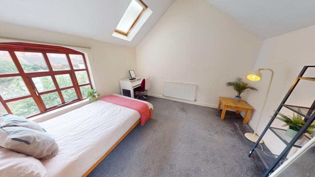 Bright and spacious master bedroom featuring a ...