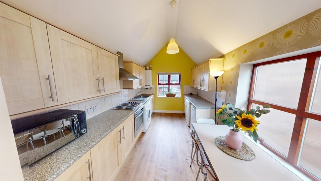Bright and modern kitchen with ample natural li...