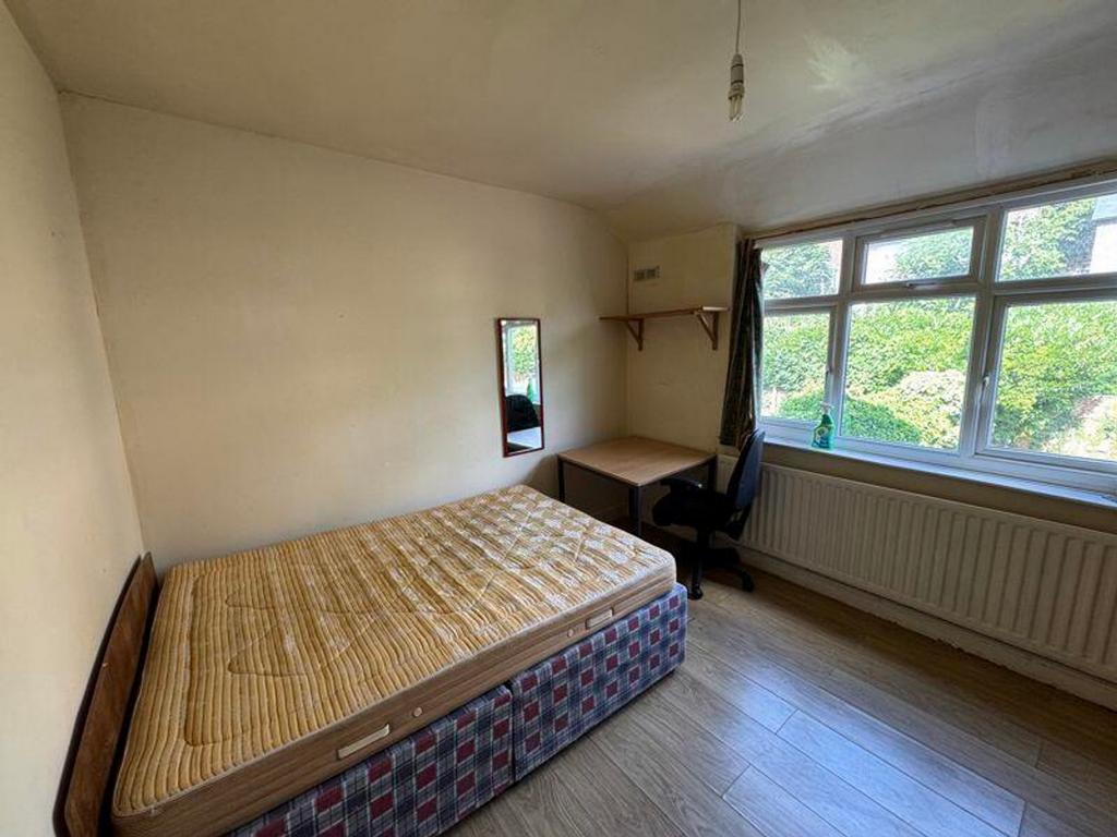 A bright and inviting double bedroom with ample...