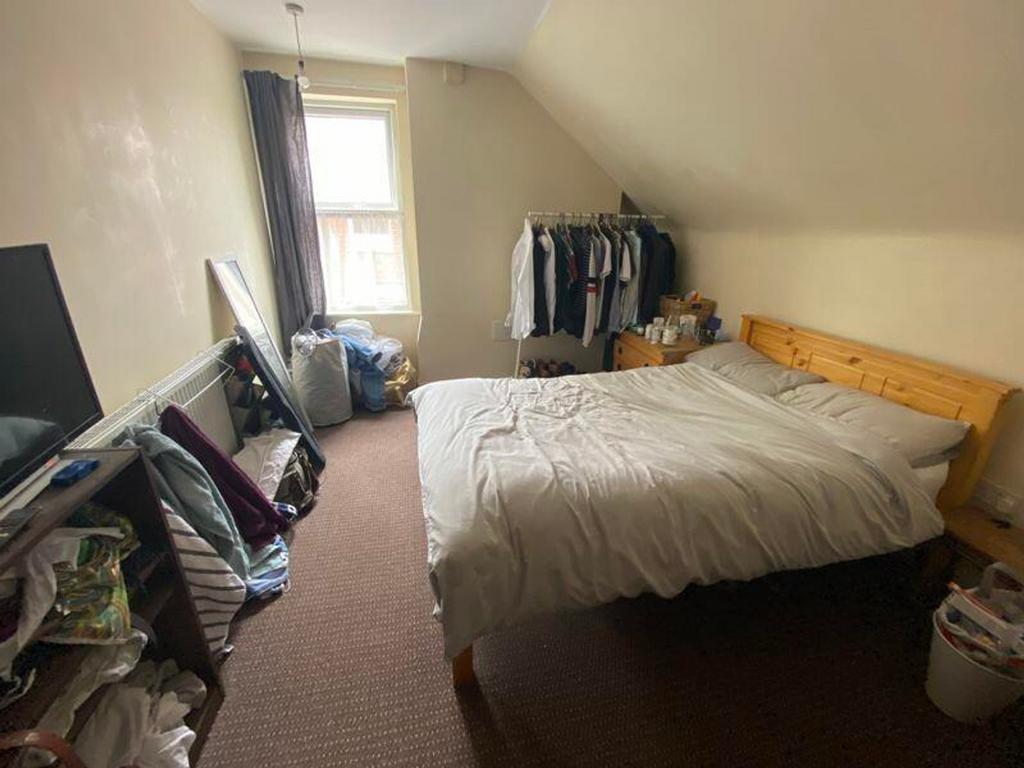 A cozy double bedroom with good natural light a...