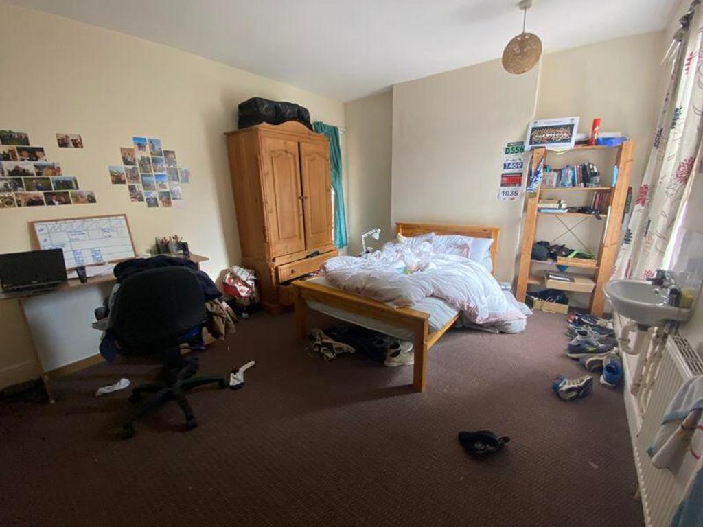 A cozy double bedroom with ample space and natu...