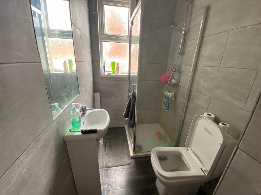 A modern and tidy bathroom featuring a shower a...