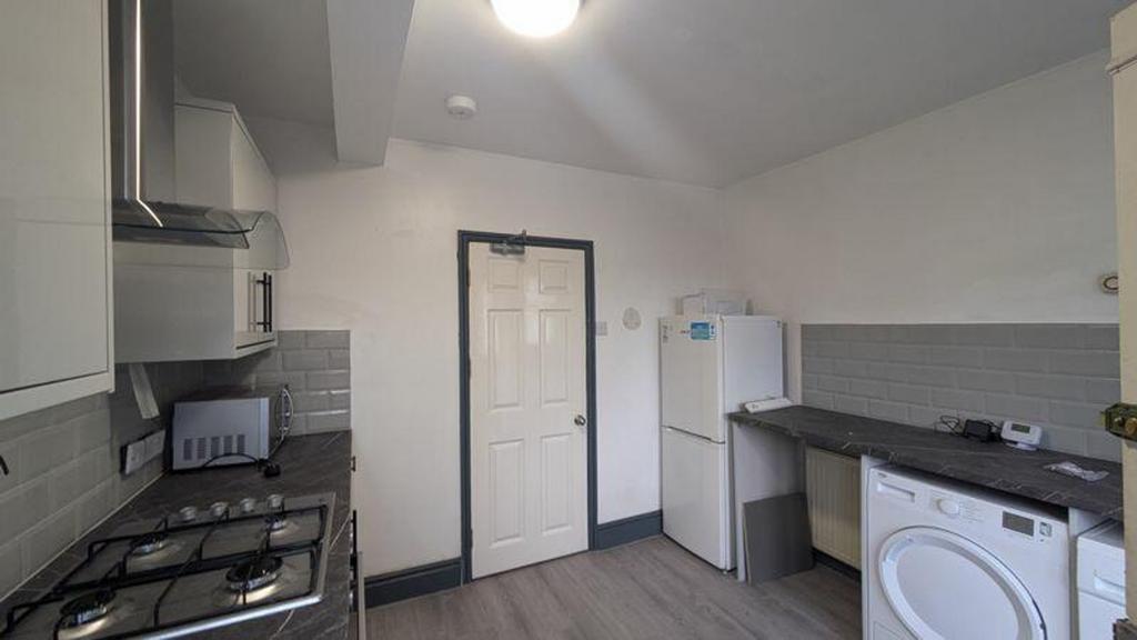 A bright and modern kitchenette with ample spac...