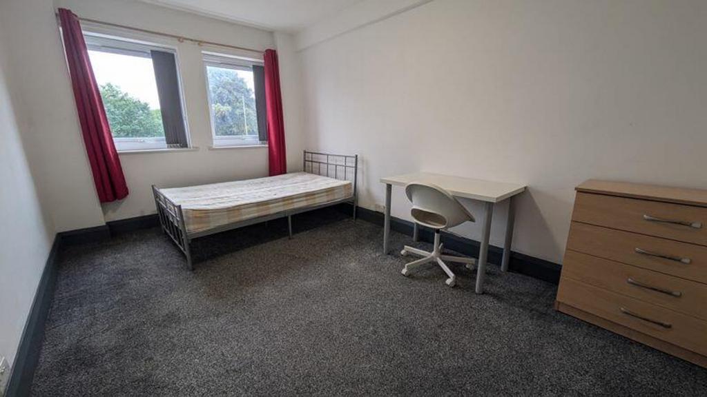 A spacious and well-lit double bedroom, featuri...