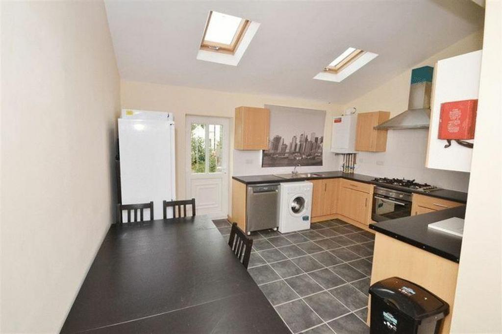 A spacious and bright kitchen with modern appli...