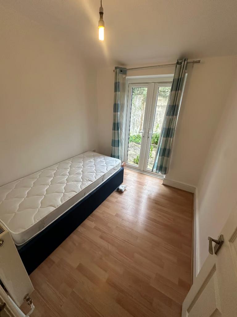 A bright and inviting double bedroom featuring ...