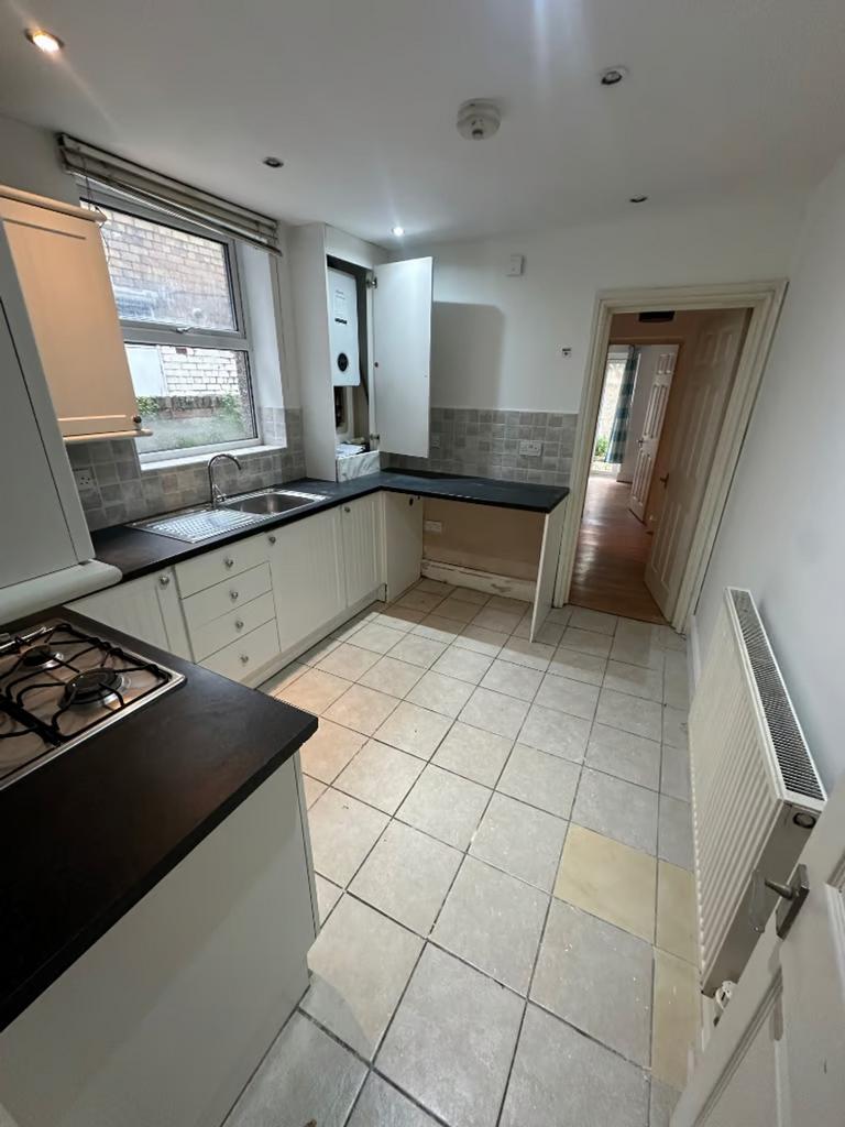 A spacious and well-lit kitchenette with modern...