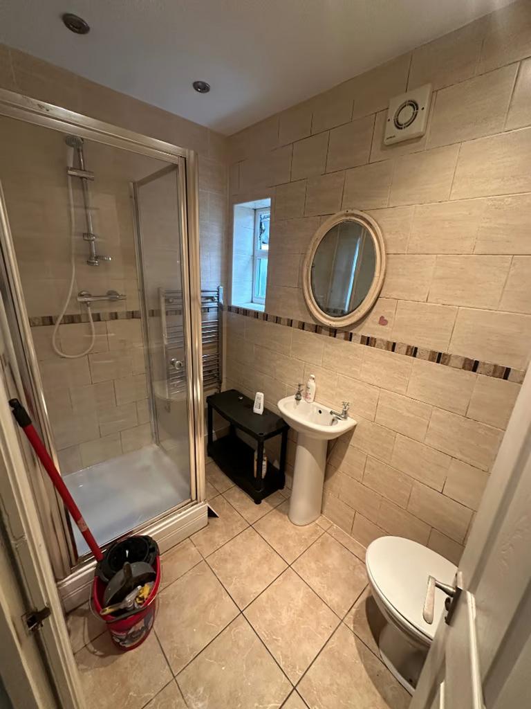 A modern and tidy bathroom featuring a shower a...