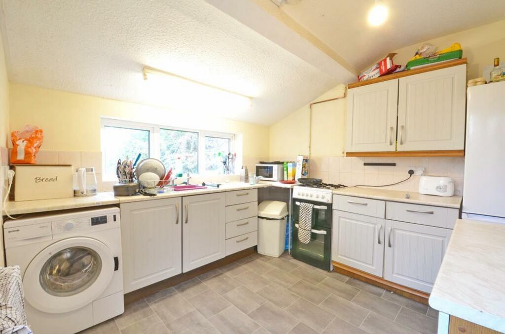 A bright and tidy kitchenette equipped with mod...