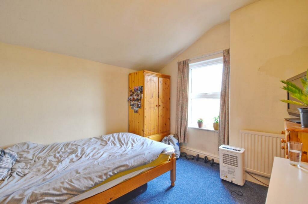 A cozy double bedroom featuring a large window ...