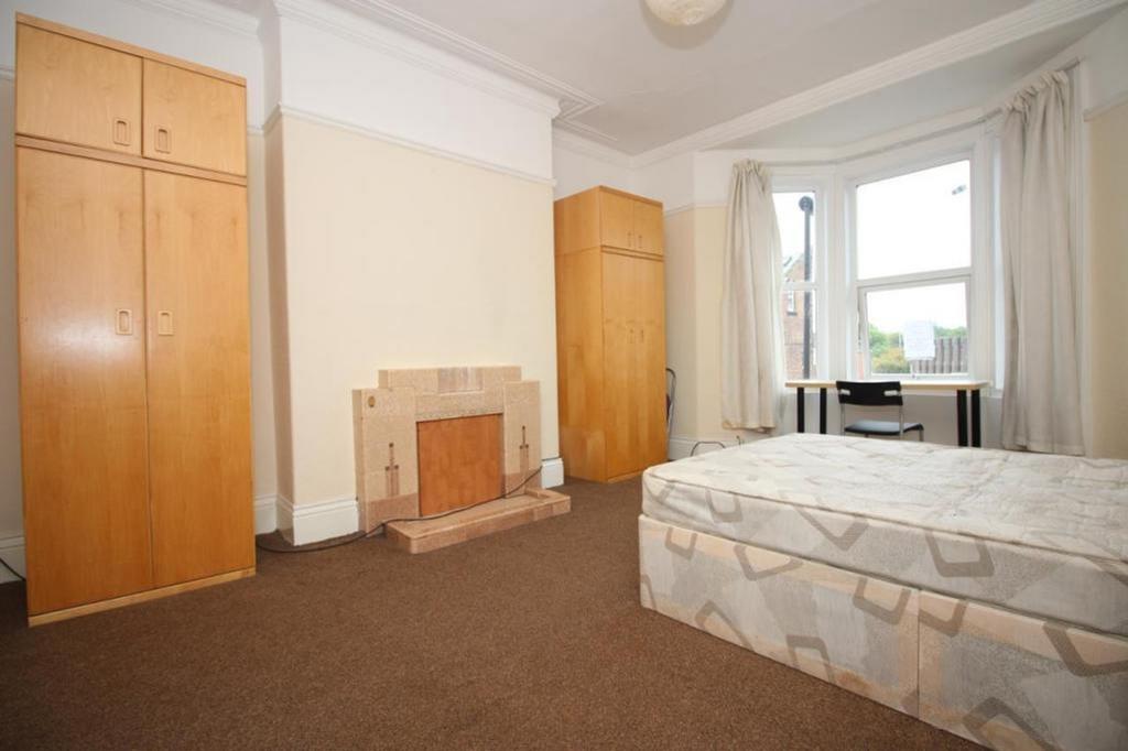 A spacious and well-lit double bedroom featurin...