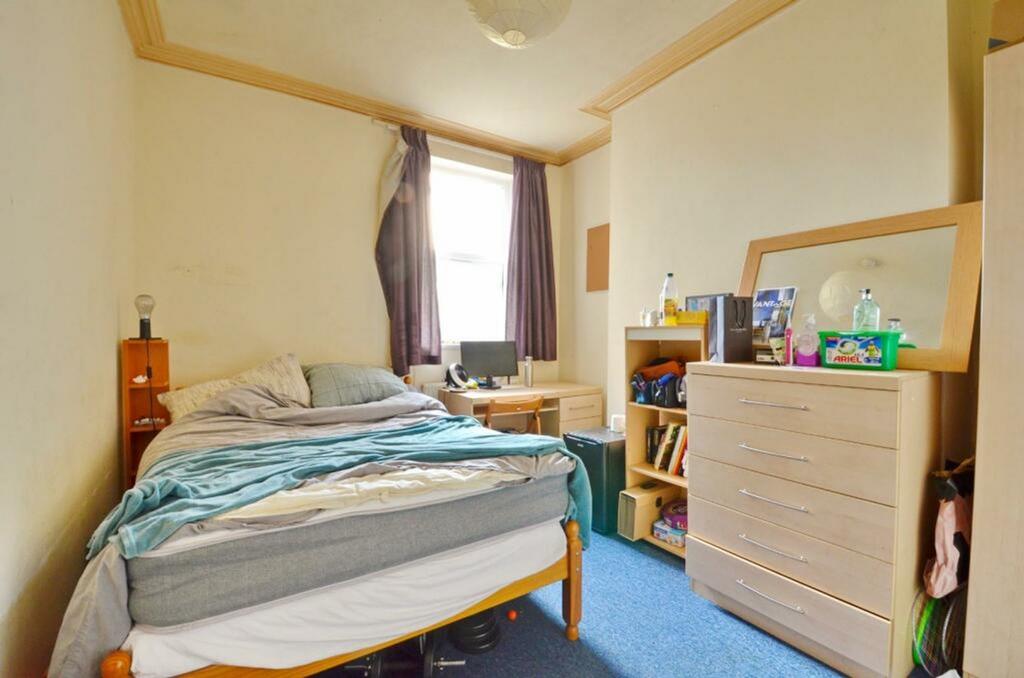 A cozy and well-lit double bedroom, perfect for...