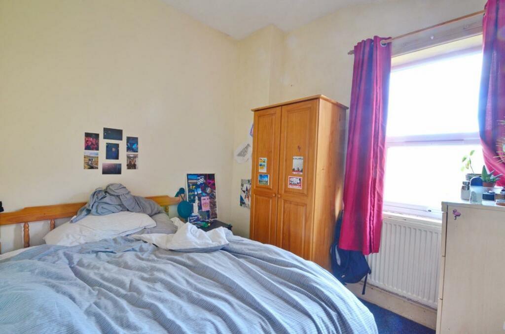 A cozy double bedroom featuring ample natural l...
