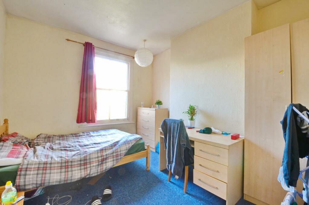 A bright and inviting double bedroom with ample...