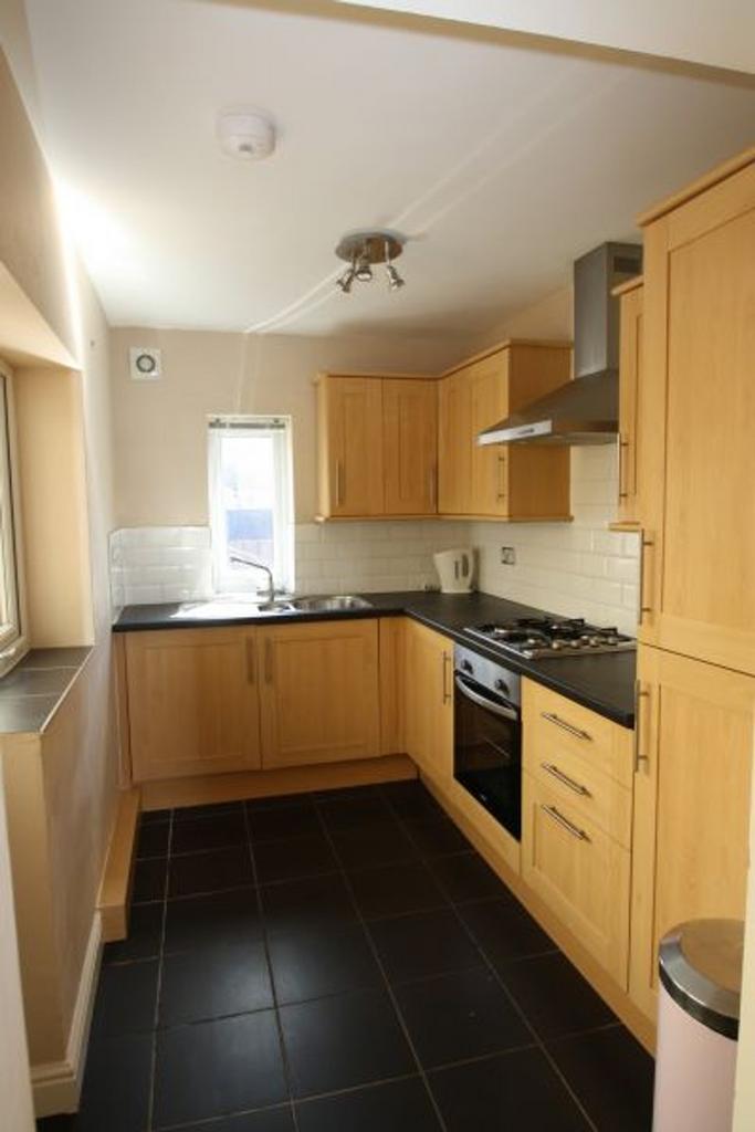 A bright and modern kitchen featuring ample sto...