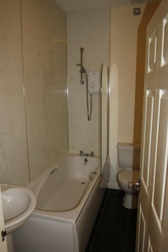 This well-maintained bathroom features a modern...