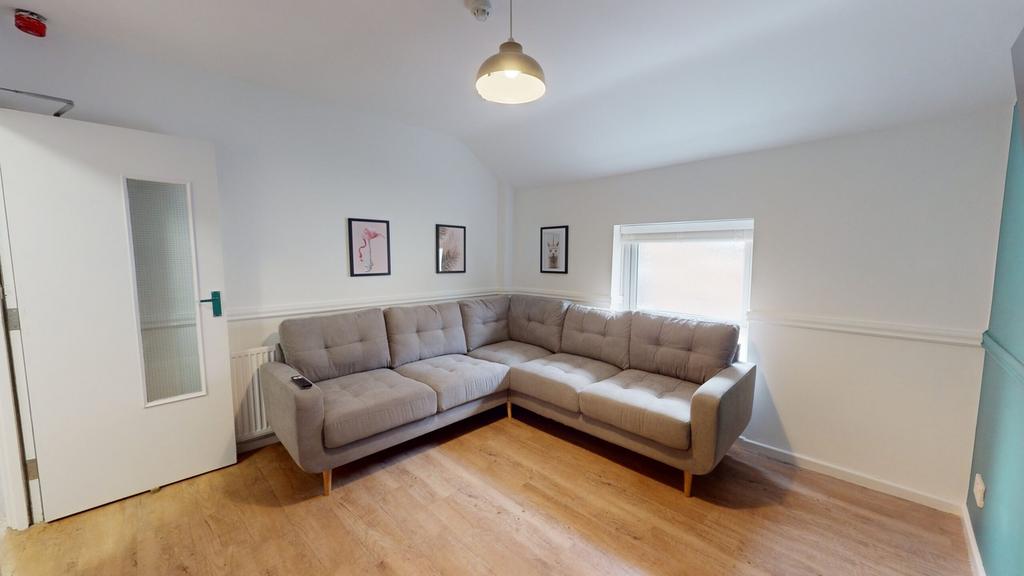 A bright and inviting living room featuring a c...