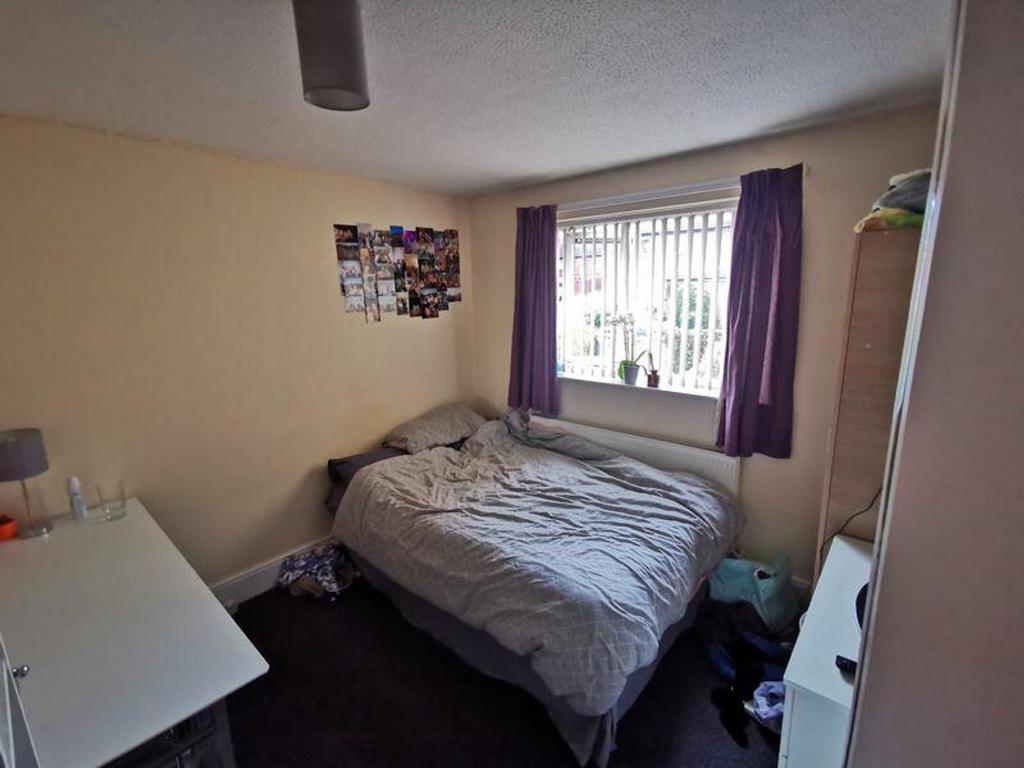 A cozy double bedroom with good natural light a...