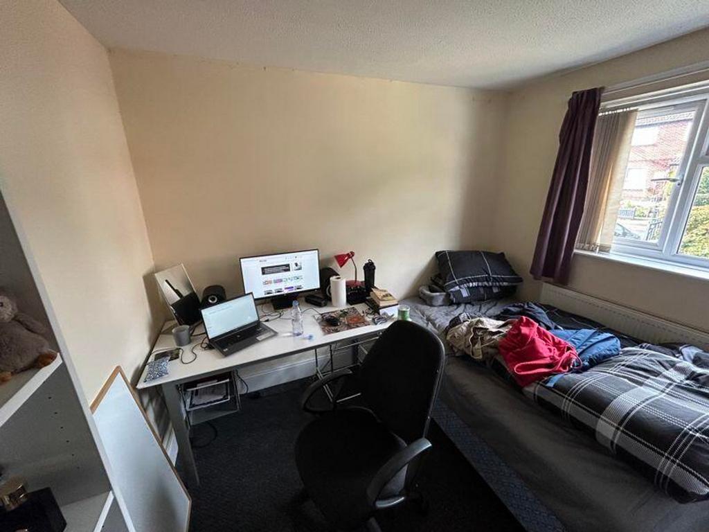 A cozy double bedroom with a workspace, offerin...