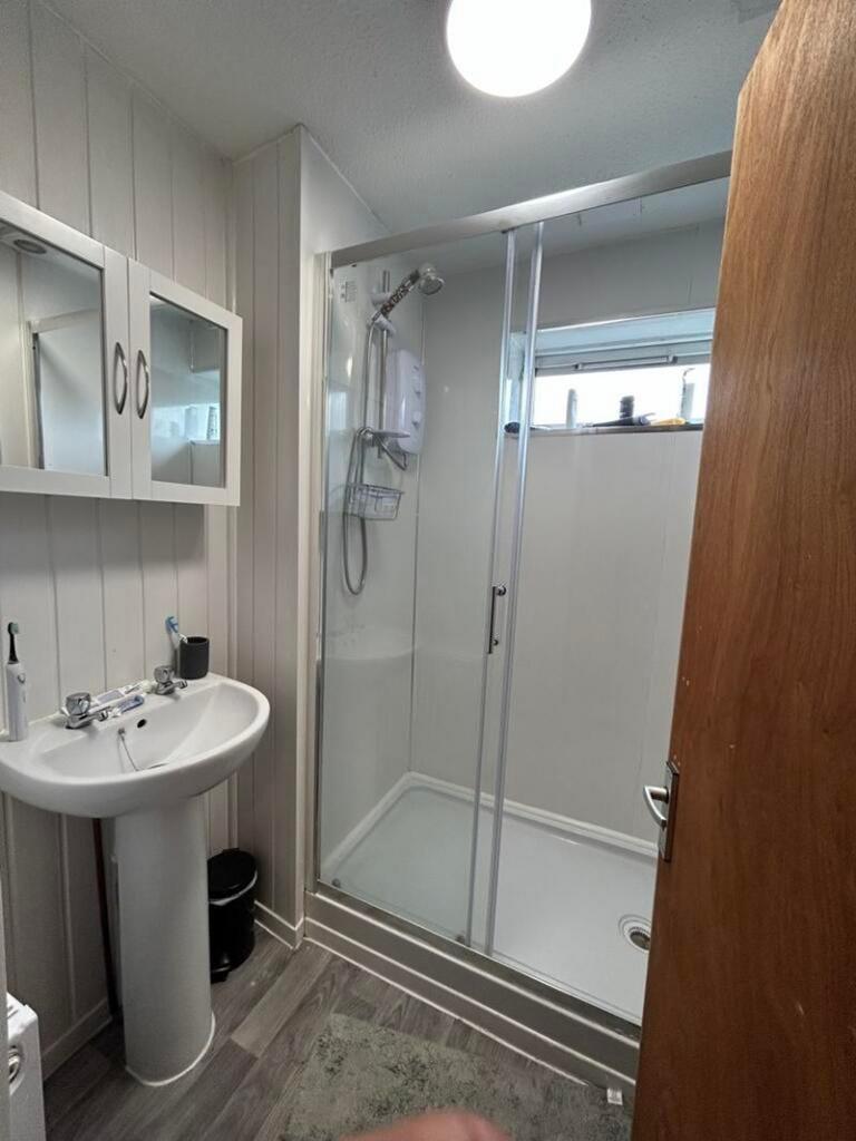 A bright and tidy bathroom featuring a modern s...