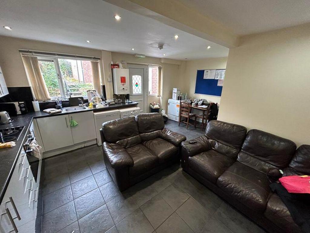 A spacious and inviting kitchen area featuring ...