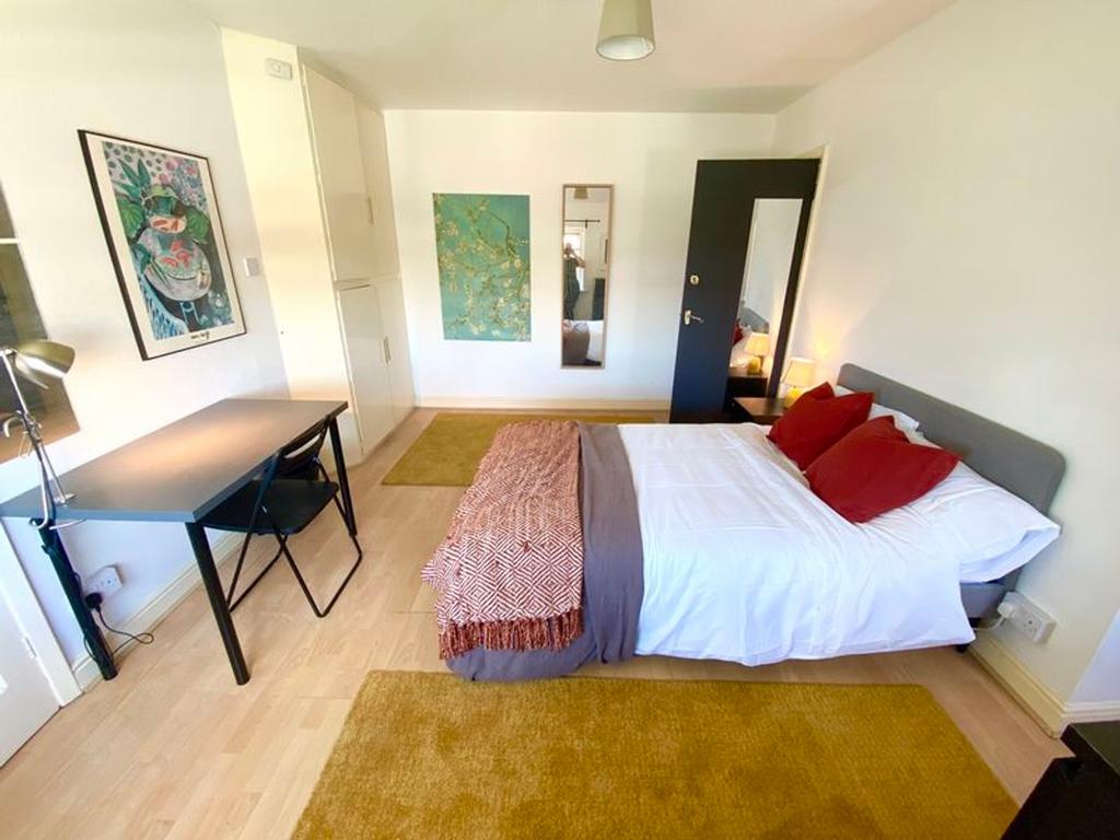 A bright and spacious double bedroom featuring ...