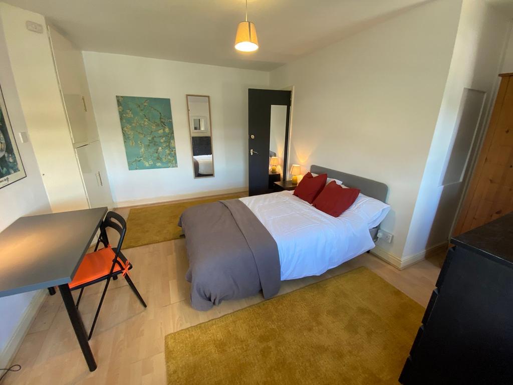 A bright and inviting double bedroom featuring ...