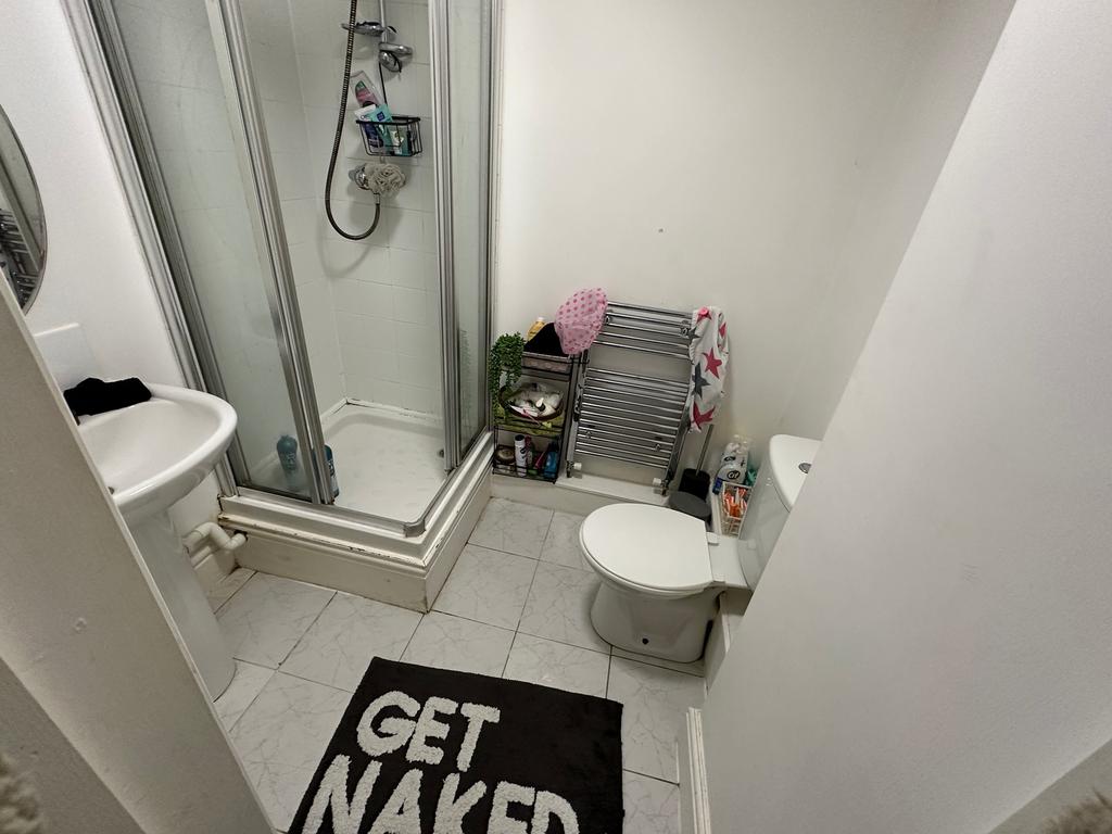 A well-maintained bathroom featuring a shower, ...