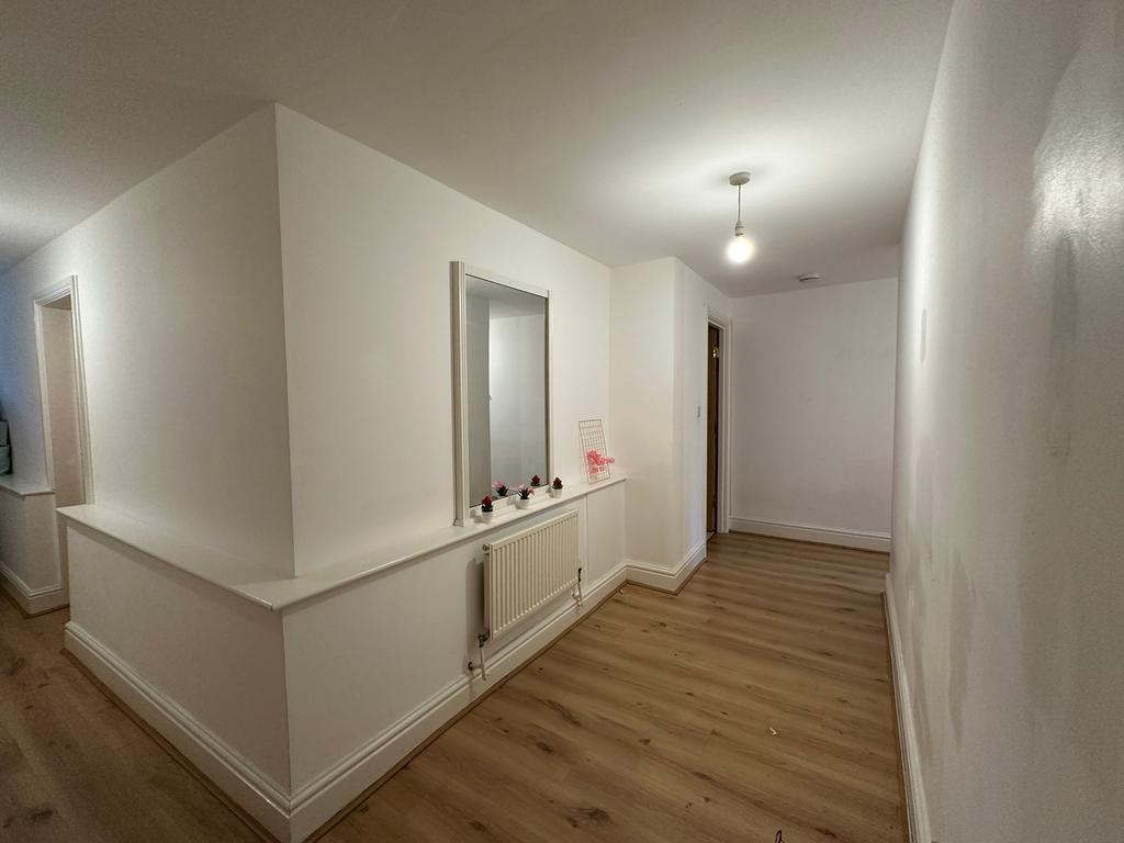 A spacious and well-maintained hallway with mod...
